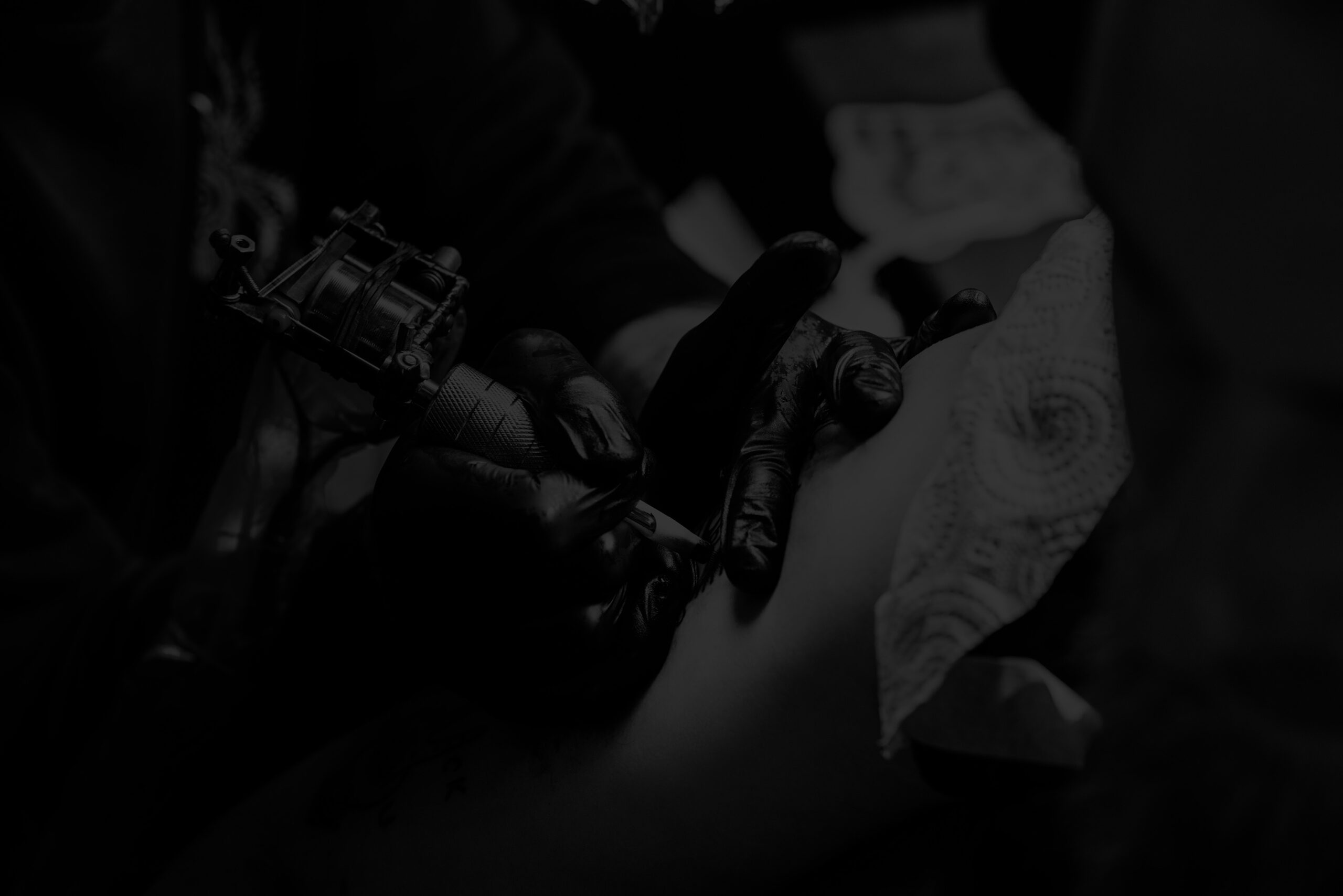 Tattoo artist working on a client at Pride Ink Maui